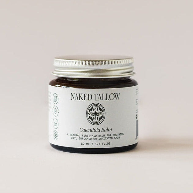 A jar of Calendula Healing Balm by Naked Tallow, placed on a neutral background.