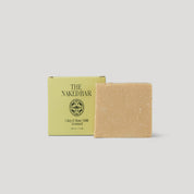 Bar of soap with a green box labeled 'The Naked Bar' on a light gray background