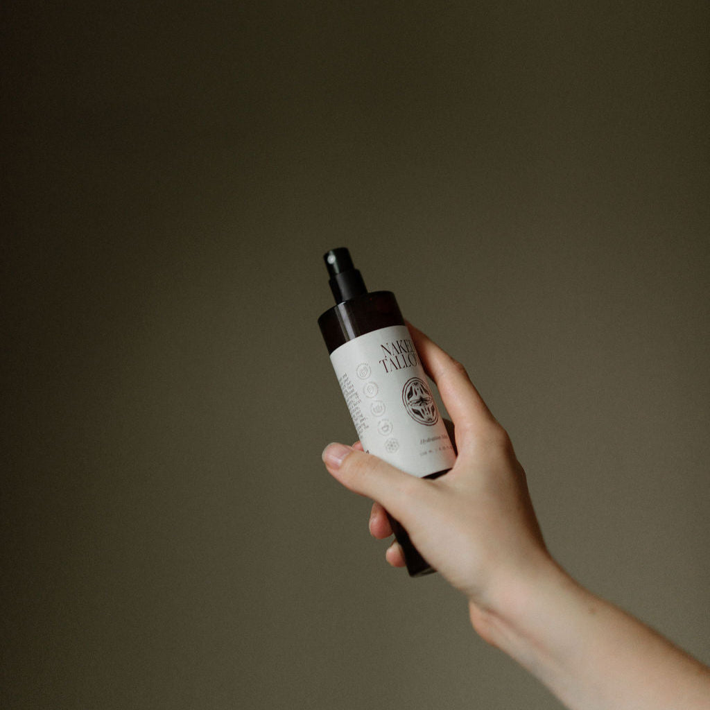 Hand holding a bottle with a label against a dark background
