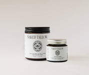 Two jars of Naked Tallow skin care products on a light background, one larger jar labeled 'Naked Tallow' and a smaller jar labeled 'Calendula Healing Balm'.