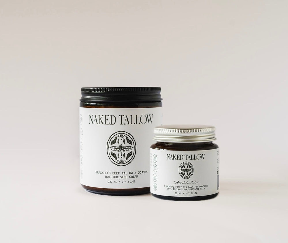 Two jars of Naked Tallow skin care products on a light background, one larger jar labeled 'Naked Tallow' and a smaller jar labeled 'Calendula Healing Balm'.