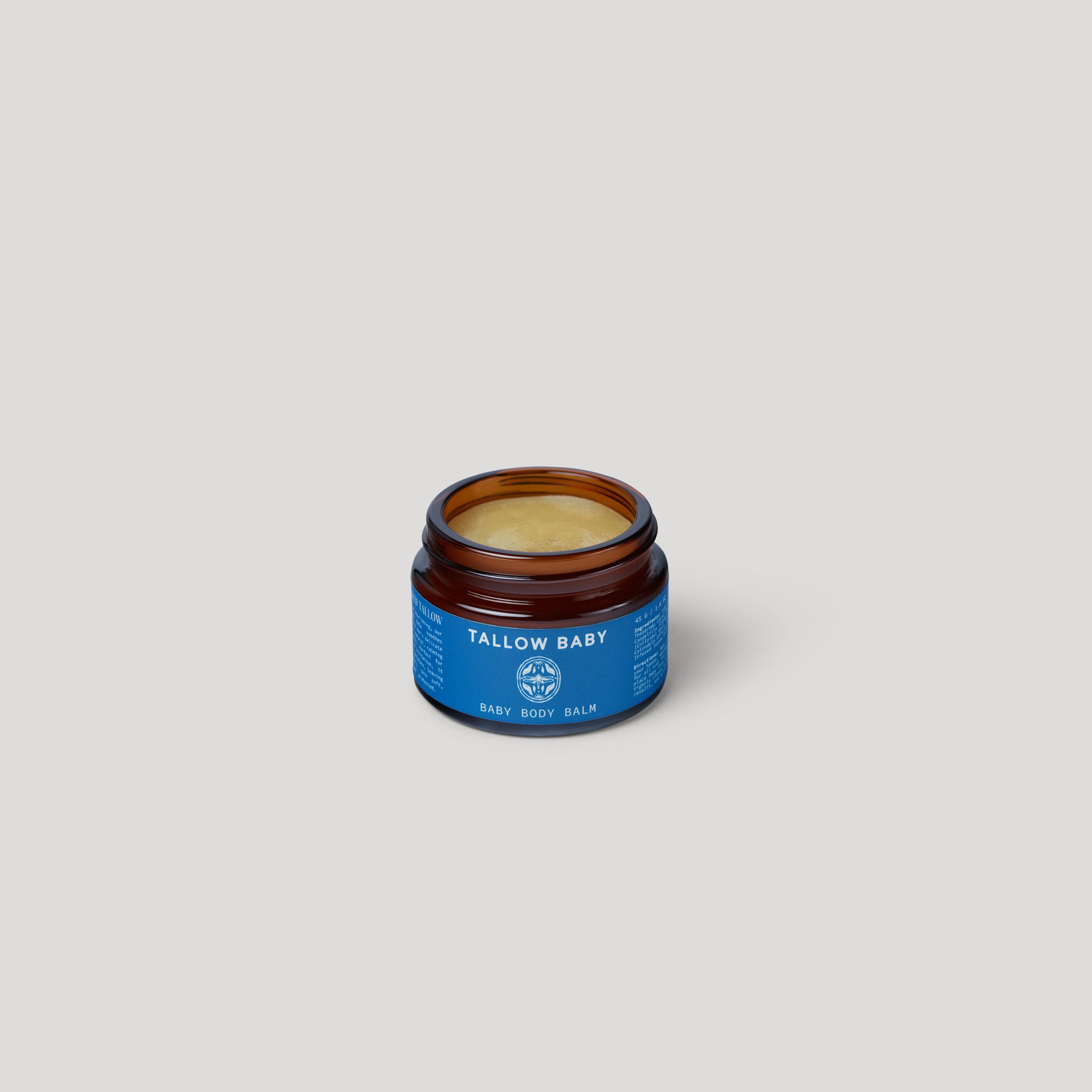 Jar of Tallow Baby balm on a light gray background